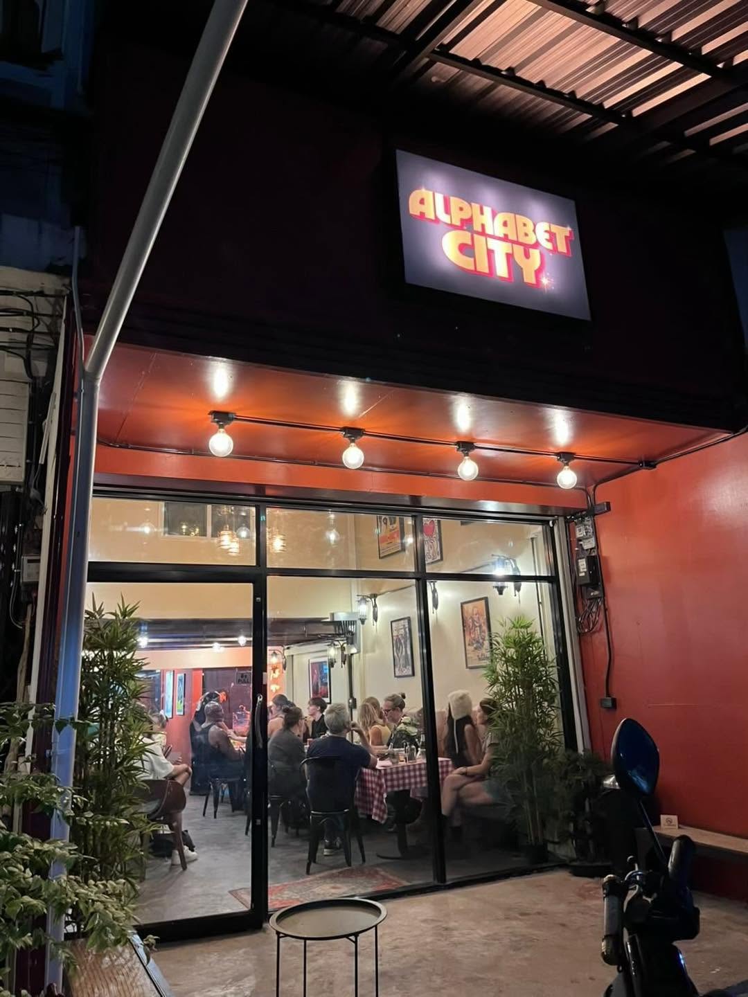 Alphabet City Pizza Co. storefront in Chiang Mai's Old City at night